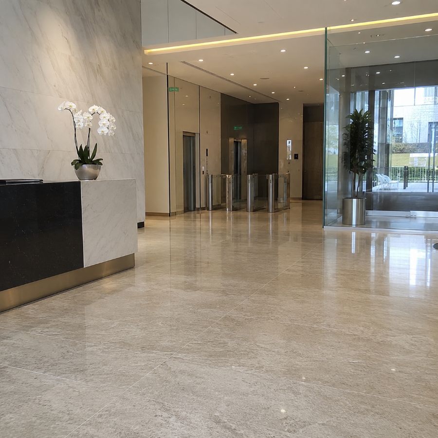 Clenova commercial cleaner wearing a black uniform and cleaning a meeting table in a modern London office