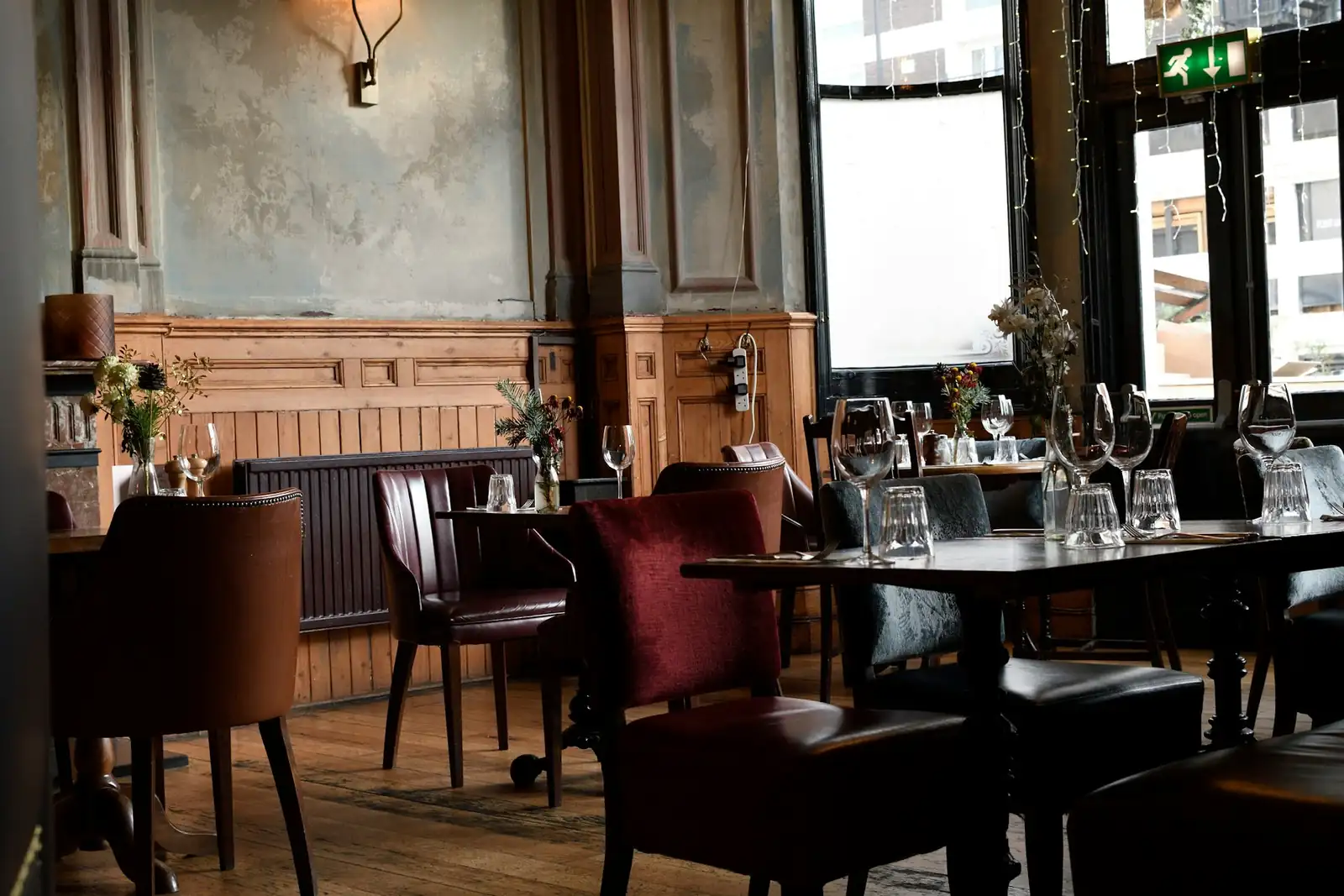 Clean restaurant dining area with wooden tables, comfortable seating and a tidy modern interior.
